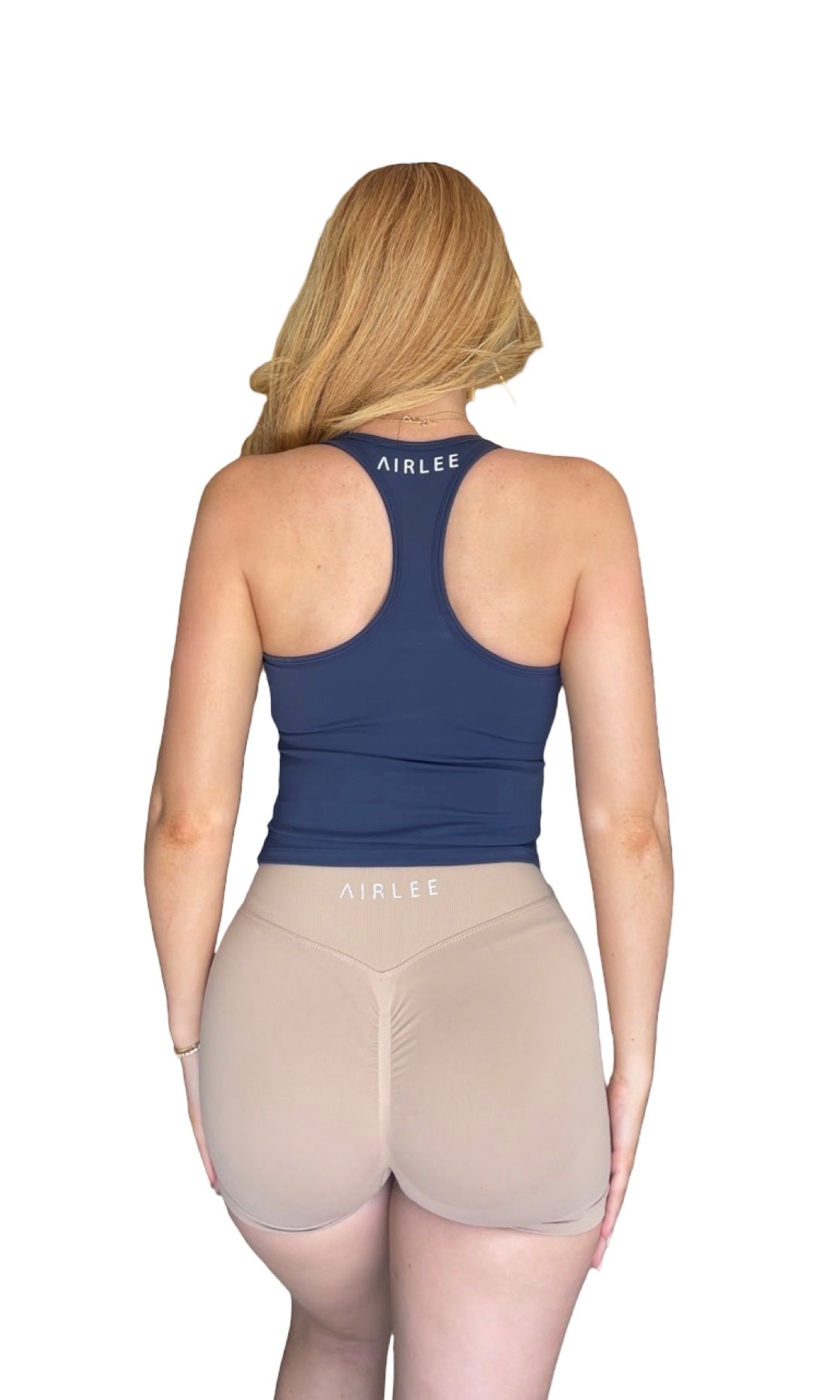 Person wearing a blue tank top and beige shorts with 'AIRLEE' branding on a white background